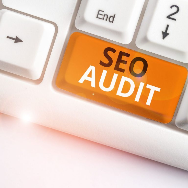 Writing note showing Seo Audit. Business concept for Search Engine Optimization validating and verifying process White pc keyboard with note paper above the white background